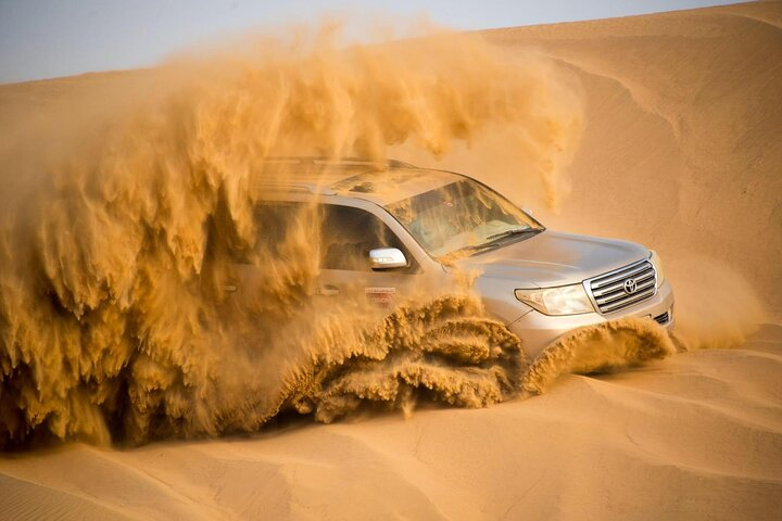 Experience the excitement of a private car evening desert safari navigating through sandy dunes followed by an unforgettable BBQ dinner under the stars with live entertainment showcasing Emirati culture.